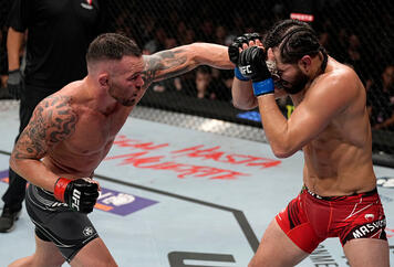 Colby Covington punches Jorge Masvidal in their welterweight fight during the UFC 272 event on March 05, 2022 in Las Vegas, Nevada. (Photo by Jeff Bottari/Zuffa LLC)